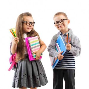 Two smiling school kids with colorful stationery
